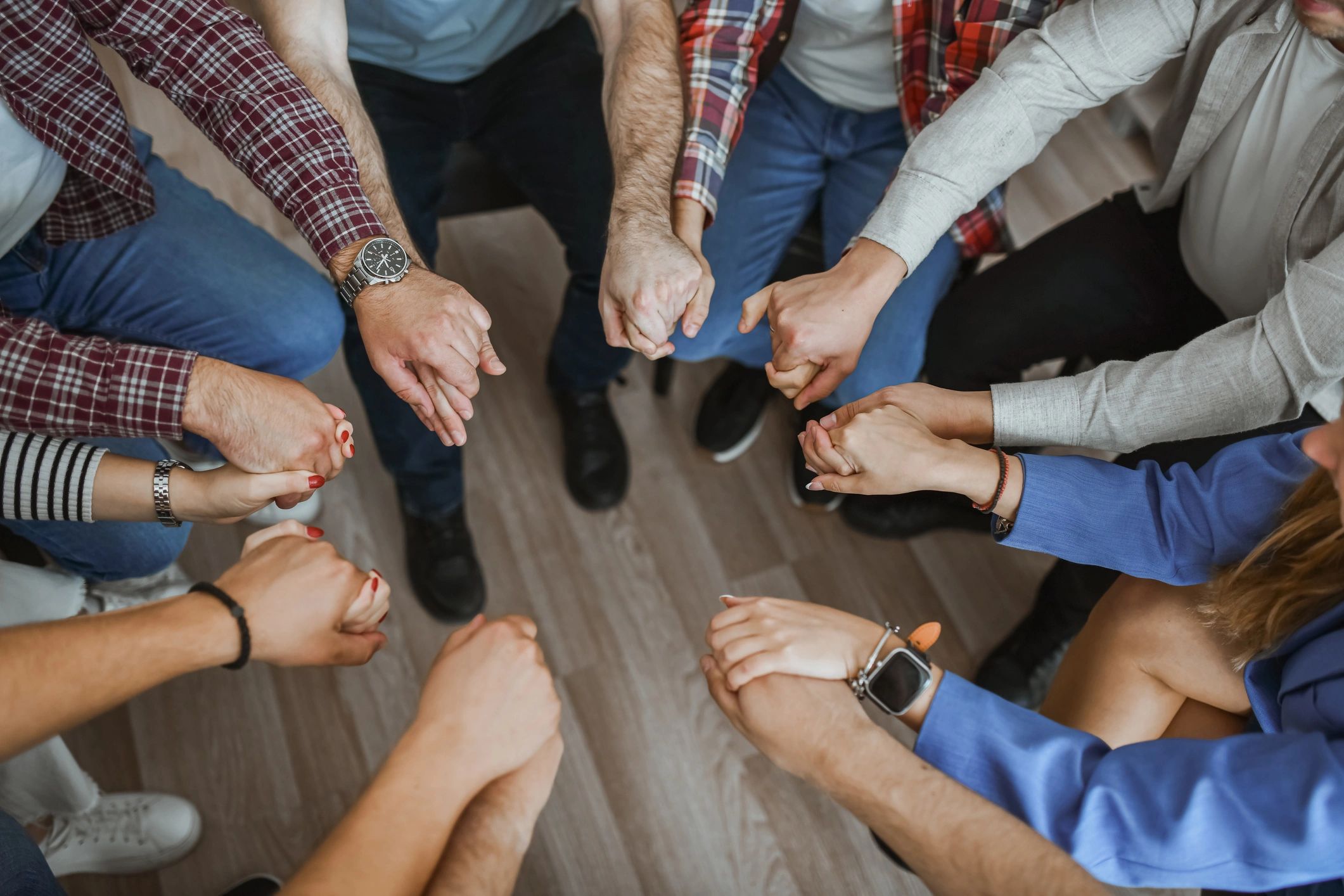 Support group holding hands in a circle
